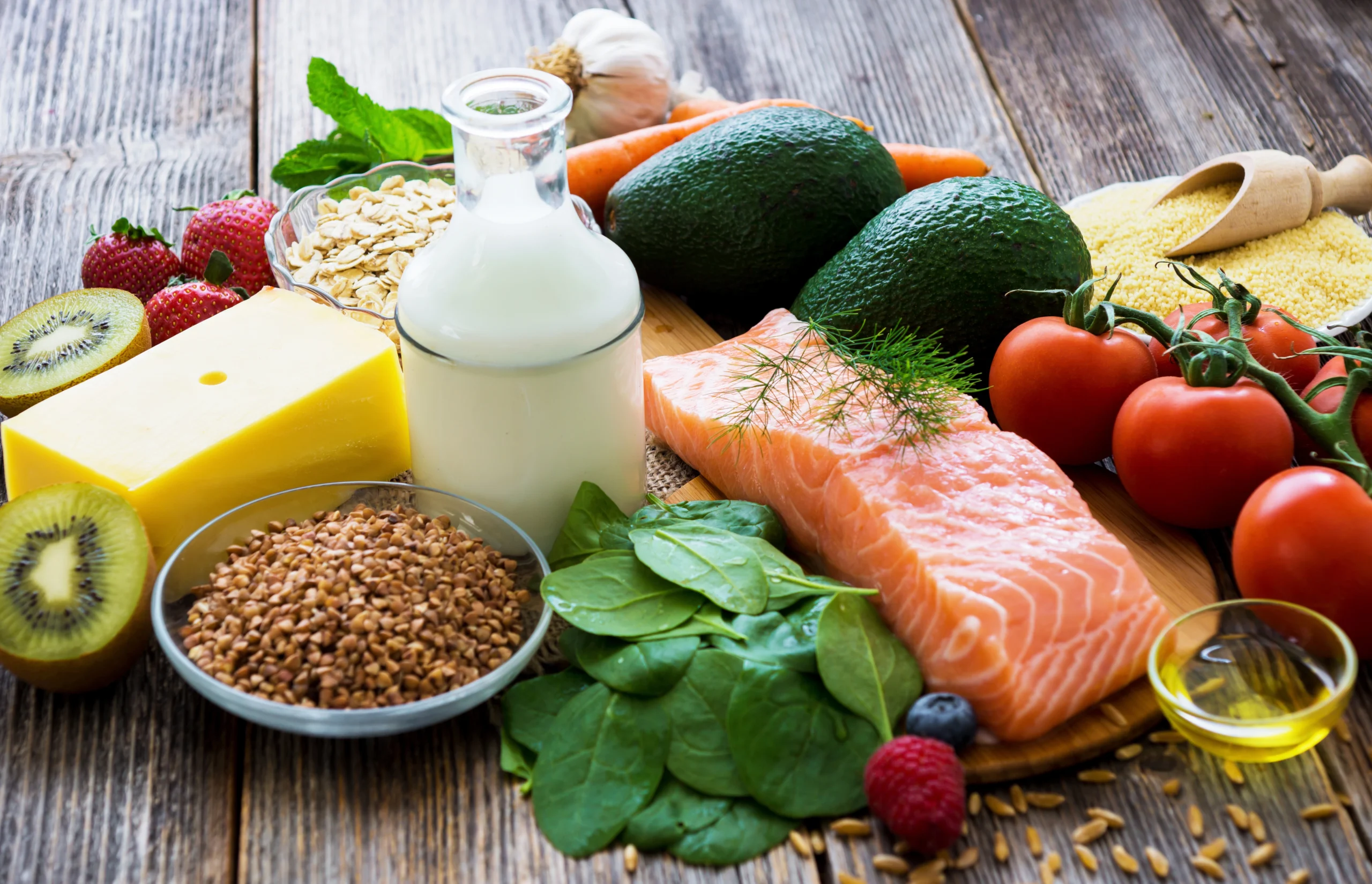 Healthy food options on a table to demonstrate nutritional options to achieve fitness goals.