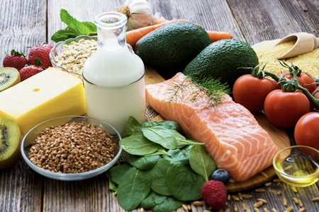 Healthy food options on a table to demonstrate nutritional options to achieve fitness goals.