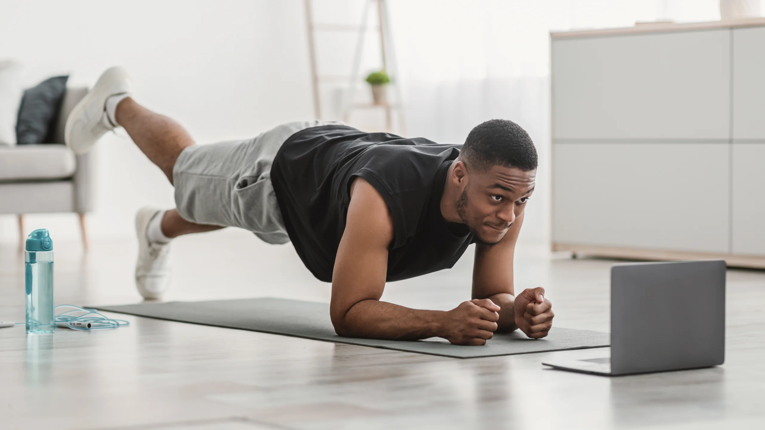 image of man holding a plank during an online personal training session.